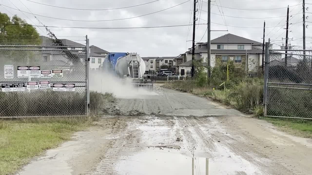 Machinery working a dirt road during stabilization